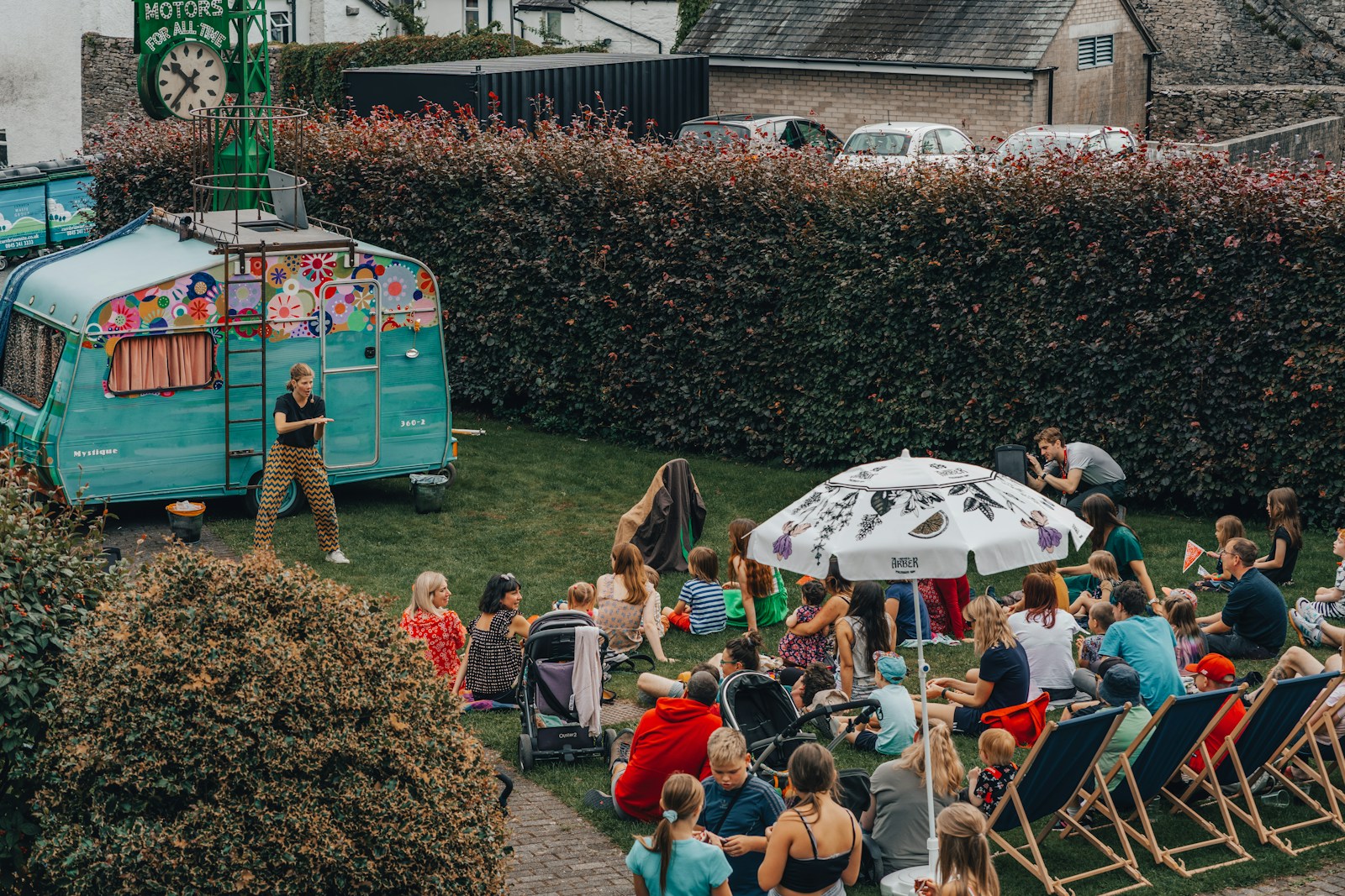 a crowd of people sitting on the grass